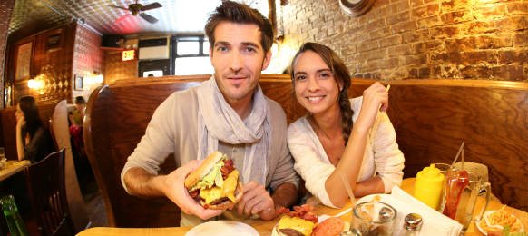 couple eating hamburger in a cafe