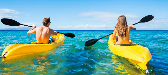 couple kayaking in the ocean on vacation