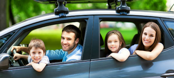 happy family inside a car ready for their vacation