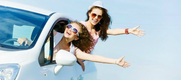 happy female friends on a road trip