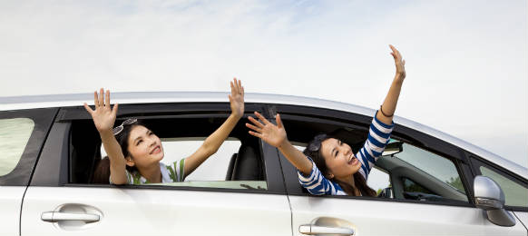 happy girls in their car rental enjoying the ride for vacation