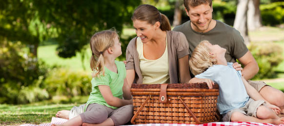 joyful family picnicking in the park