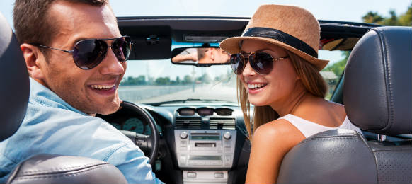 traveling couple in a convertible car rental