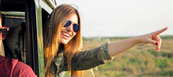 woman pointing out of the car rental